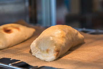 Argentine empanada meat pie pastries for sale in a bakery window