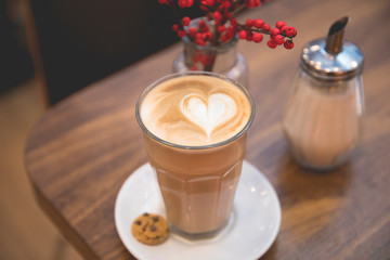 View of a delicious cappuccino or cafe latte with a milk heart shape pattern