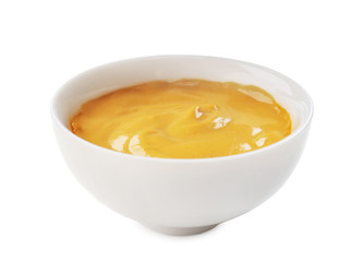 Tasty yellow sauce in bowl on white background