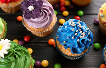 Tasty cupcakes on dark wooden background