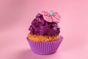Tasty cupcake on color background
