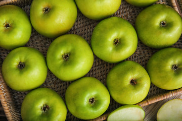 Ripe tasty apples in wicker tray
