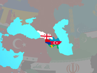 Obraz premium Caucasus region with national flags on blue political globe.