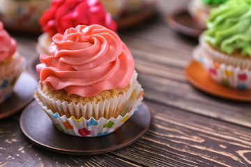 Tasty cupcake on wooden background