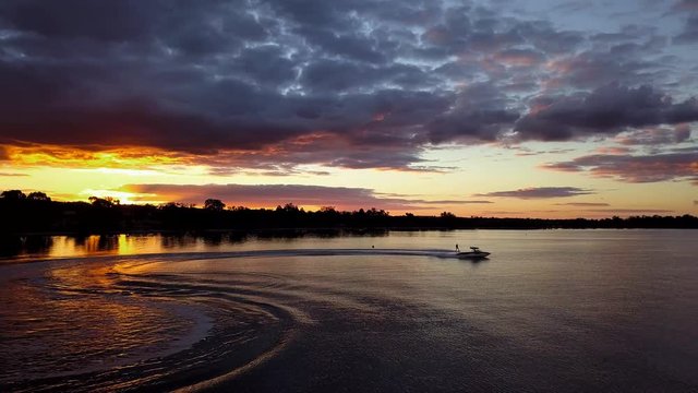 Wakeboarding 360 whips on lake aerial boat
