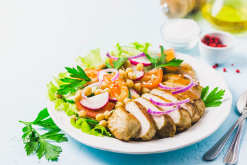 Grilled chicken with fresh vegetables olive oil dressing. Selective focus, Space for text.