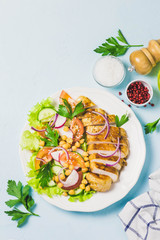 Grilled chicken with fresh vegetables olive oil dressing. Selective focus, Space for text.