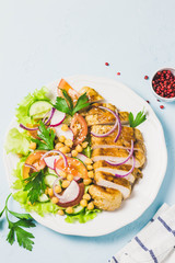 Grilled chicken with fresh vegetables olive oil dressing. Selective focus, Space for text.