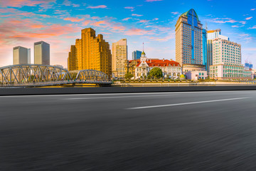 Fototapeta premium Empty asphalt road along modern commercial buildings in China's cities