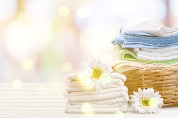 Fototapeta na wymiar Laundry Basket with colorful towels on background