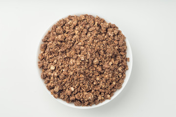 Granola breakfast on a bowl over white background