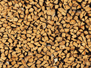 Raw timber, wooden sawen logs stacked. Raw firewood in a lumber staging, storage yard