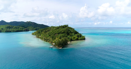Summer island in the Pacific with lagoon. Perfect view for travel and tourism in French Polynesia - aerial view with a drone - Vacation and tourism concept	
