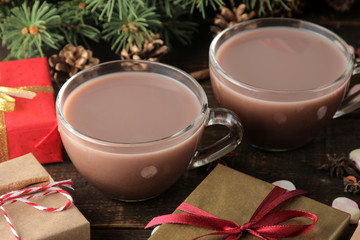 hot cocoa in a glass cup on a brown wooden background. Winter. new Year. Christmas. tree gifts