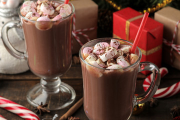 hot cocoa with marshmallows in a glass cup on a brown wooden background. Winter. new Year. Christmas. tree gifts