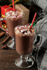 hot cocoa with marshmallows in a glass cup on a brown wooden background. Winter. new Year. Christmas. tree gifts