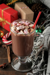 hot cocoa with marshmallows in a glass cup on a brown wooden background. Winter. new Year. Christmas. tree gifts