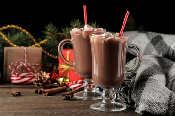 Fotobehang hot cocoa with marshmallows in a glass cup on a brown wooden background. Winter. new Year. Christmas. tree gifts © MK studio