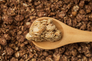 A bunch of granola and a wooden spoon, the view from the top.