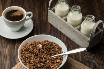 Healthy breakfast fresh cereal, milk bottle, coffee cup.