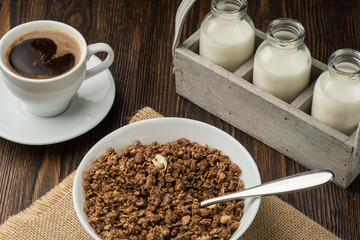 Healthy breakfast fresh cereal, milk bottle, coffee cup.