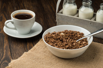 Healthy breakfast fresh cereal, milk bottle, coffee cup.