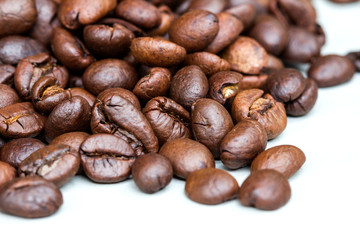 Roasted coffee beans isolated on a white background.