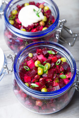 Vinaigrette salad with olive (vegetable) oil in a jar. Selective focus, close-up.