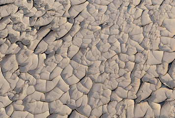Cracks in the clay as a background top view