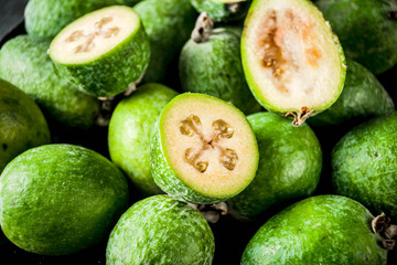 Tropical fruit, raw organic feijoa on a dark blue concrete background, copy space