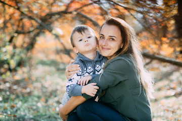 Fototapeta premium mother with son three years in autumn the forest, embrace and tenderness