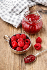Bowl of raspberries and red jam.