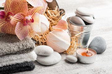Spa still life with bath bombs and red orange orchid