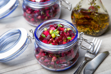 Fototapeta na wymiar Vinaigrette salad with olive (vegetable) oil in a jar. Selective focus, close-up.