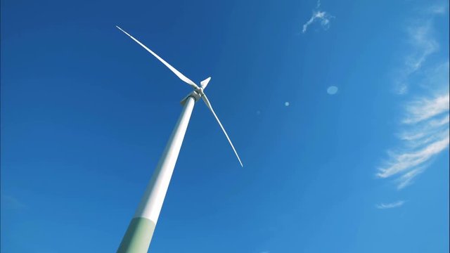 Revolving wind turbine against the background of the sky. Renewable alternative energy, environment friendly concept.