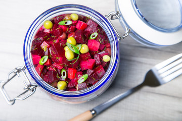 Vinaigrette salad with olive (vegetable) oil in a jar. Selective focus, close-up.