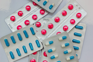 tablets and capsules in blisters are on the table