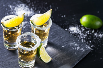 Three piles of mexican tequila with lime and salt
