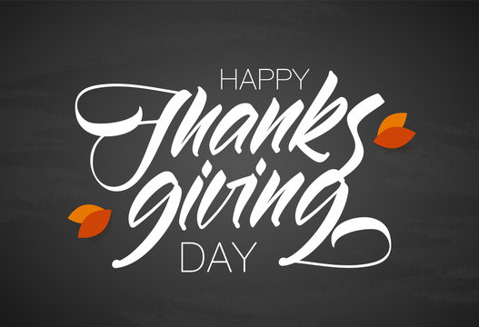Happy Thanksgiving Day. Vector Handwritten calligraphic lettering with autumn leaves on chalkboard background.