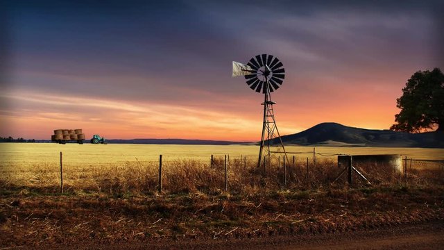 Farm animation with moving windmill and tractor moving wheat