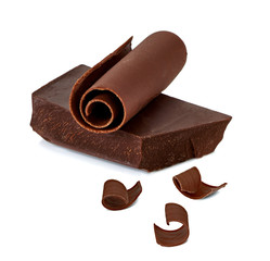 Chocolate curls and chocolate bars, chips or pieces isolated on white background