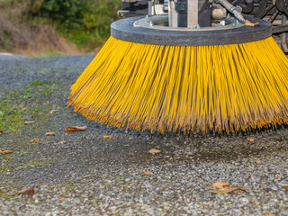Fototapeta premium Brushes of cleaning street machine in the road