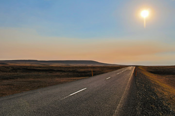 Fototapeta na wymiar A long highway road with a view up to the horizon in a desert, Iceland