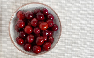 Wild Plum in little bowl on napery with clipping path