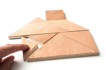 closeup of tangram piece of construction game on white background - Concept construction