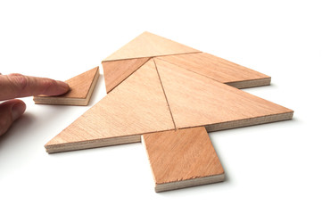 closeup of tangram piece of construction game on white background - Concept christmas