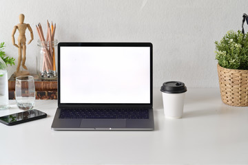 Fototapeta premium Designer workspace with blank white screen laptop and office accessories