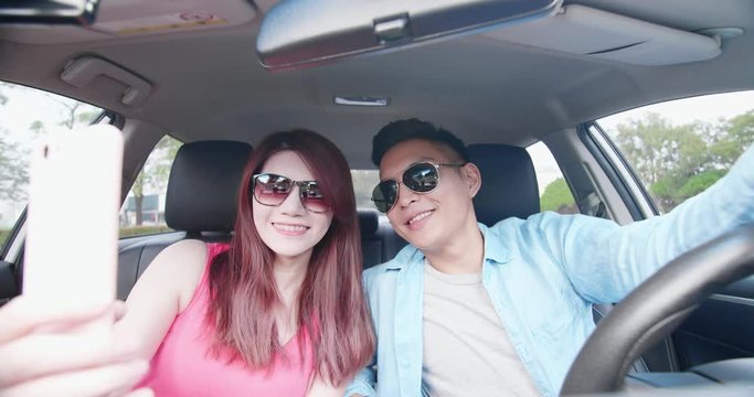 couple take selfie in car