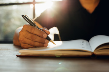 Checklist Writing Notice Remember Planning Concept,home office desk background,hand holding pen and...