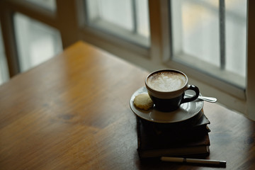 Latte art coffee on wooden desk and copy space.